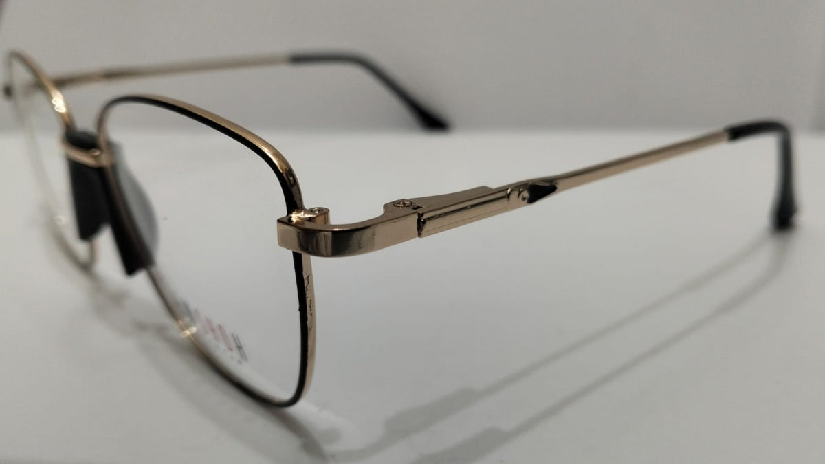 Angled view of EW SHDH black and gold eyeglasses