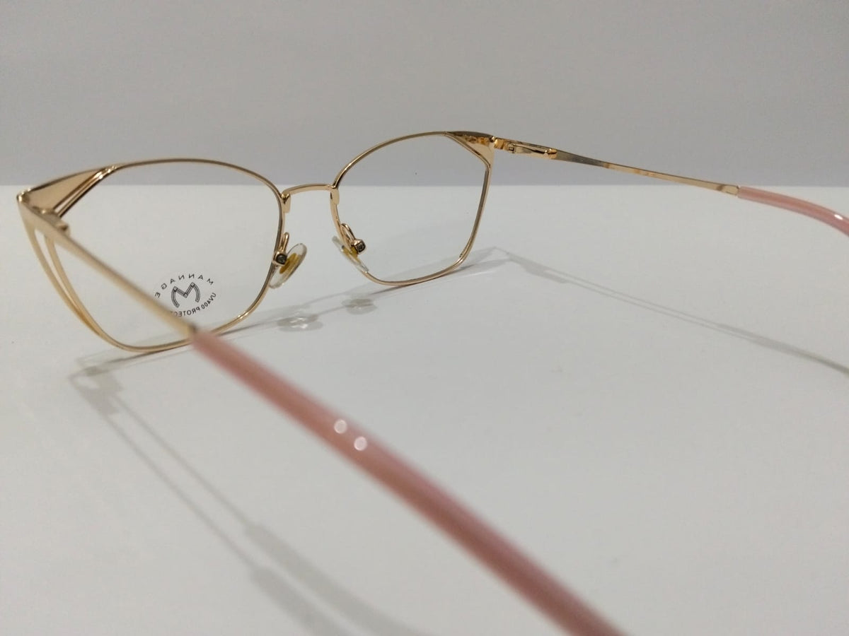 Angled view of gold cat-eye glasses with pink temple tips