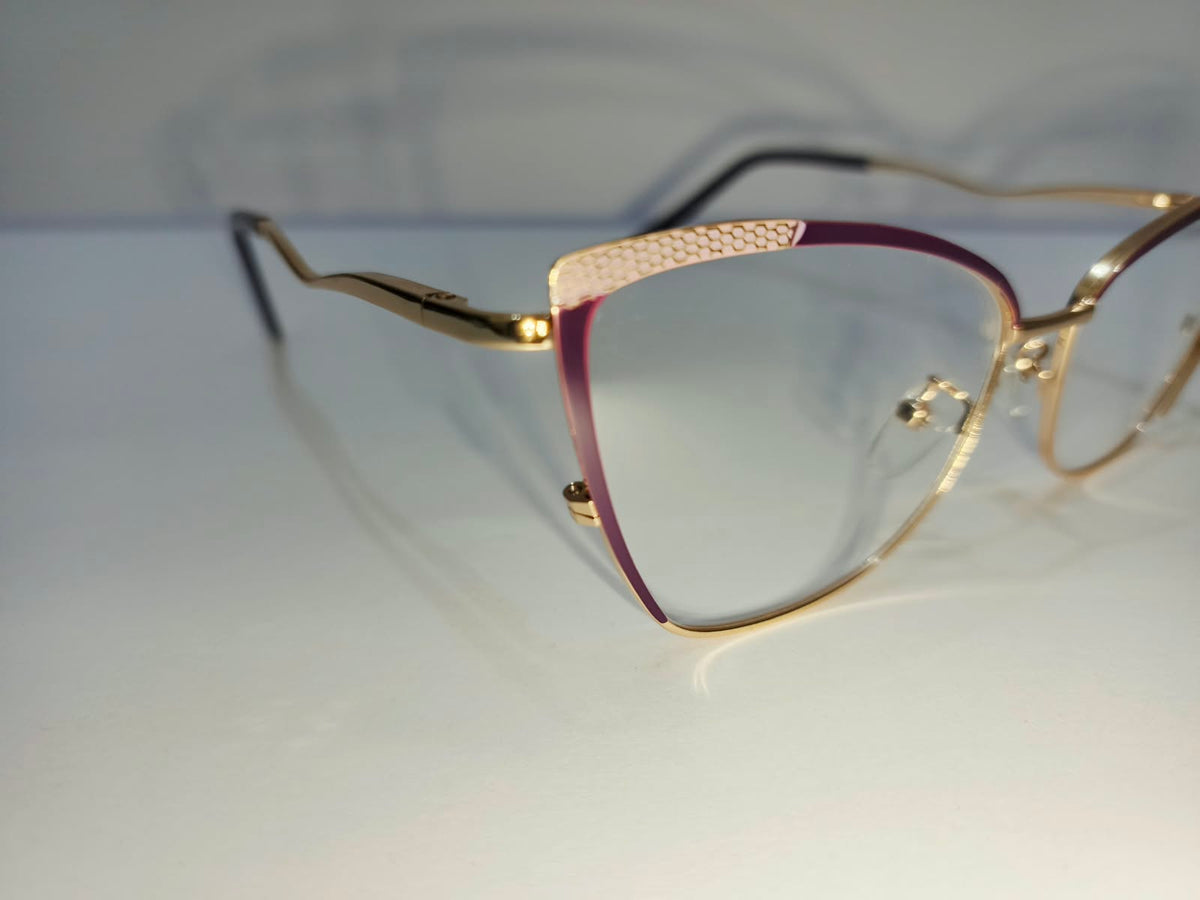 Angled view: gold-tone eyeglass frame with maroon accents