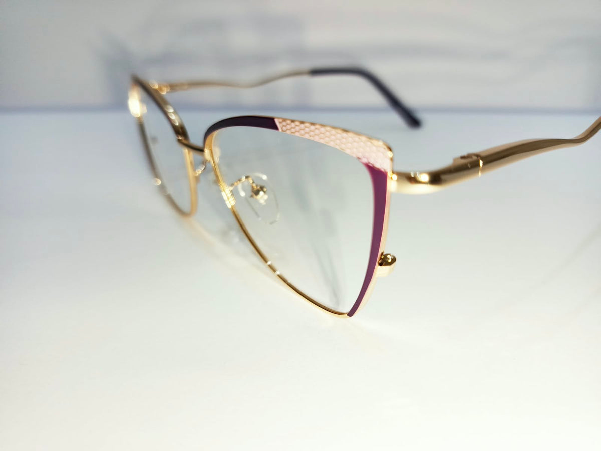 Close detail of gold and maroon eyeglass frame