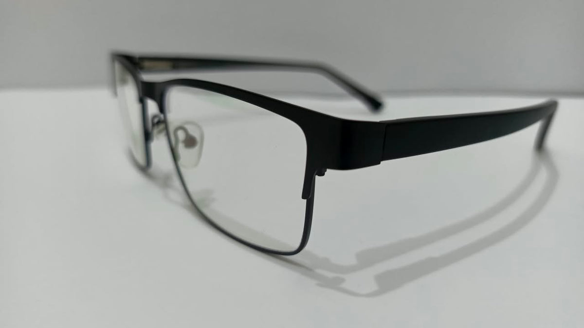 Three-quarter view of gunmetal black half-rim eyeglasses