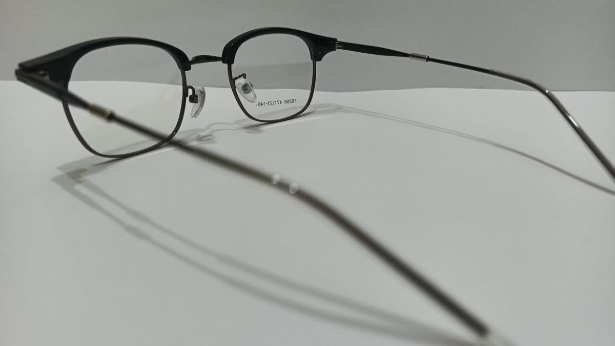 Angled view of shiny black browline prescription eyeglasses