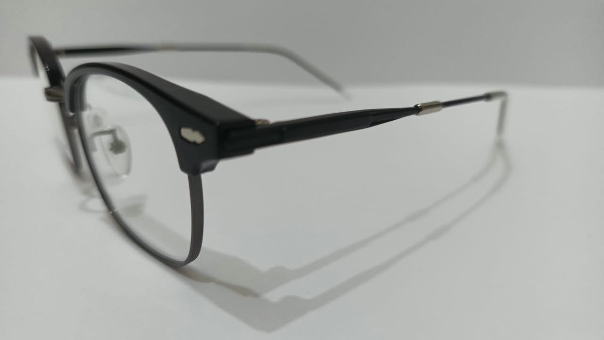 Three-quarter side view of shiny black browline eyeglasses