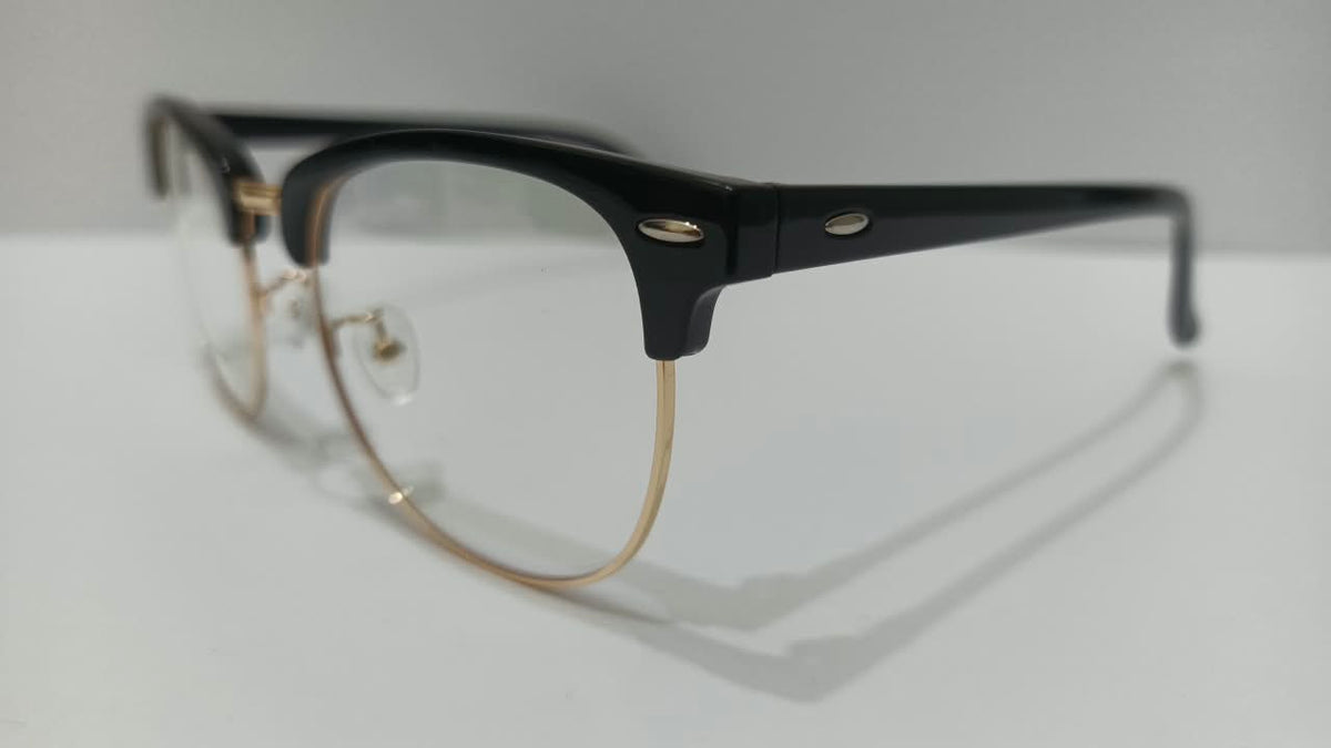 Side view of black browline eyeglasses with gold-tone rims