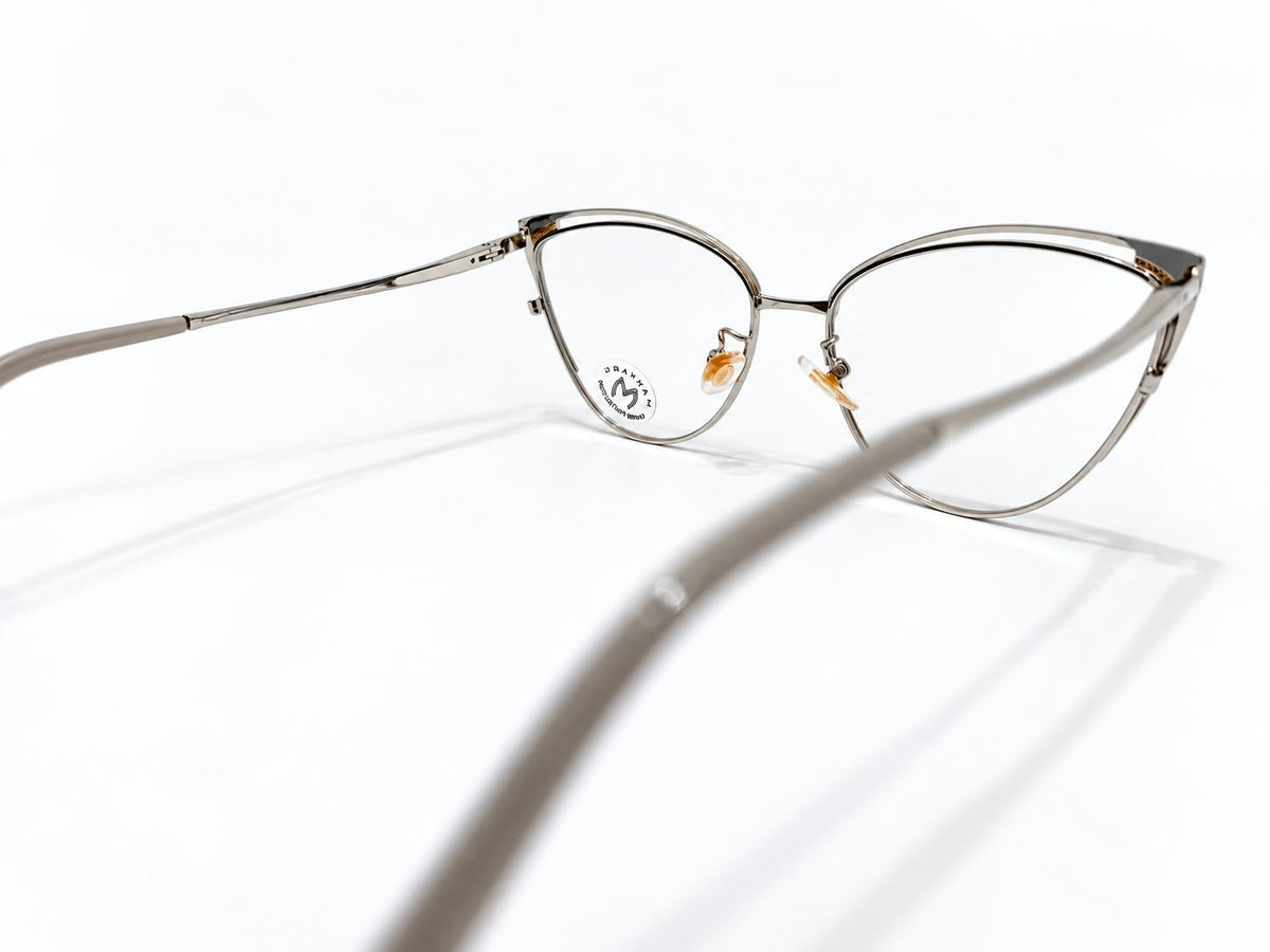 Ladies slate grey and silver-tone cat-eye prescription eyeglasses with gold-tone corner details, size 52-17-134