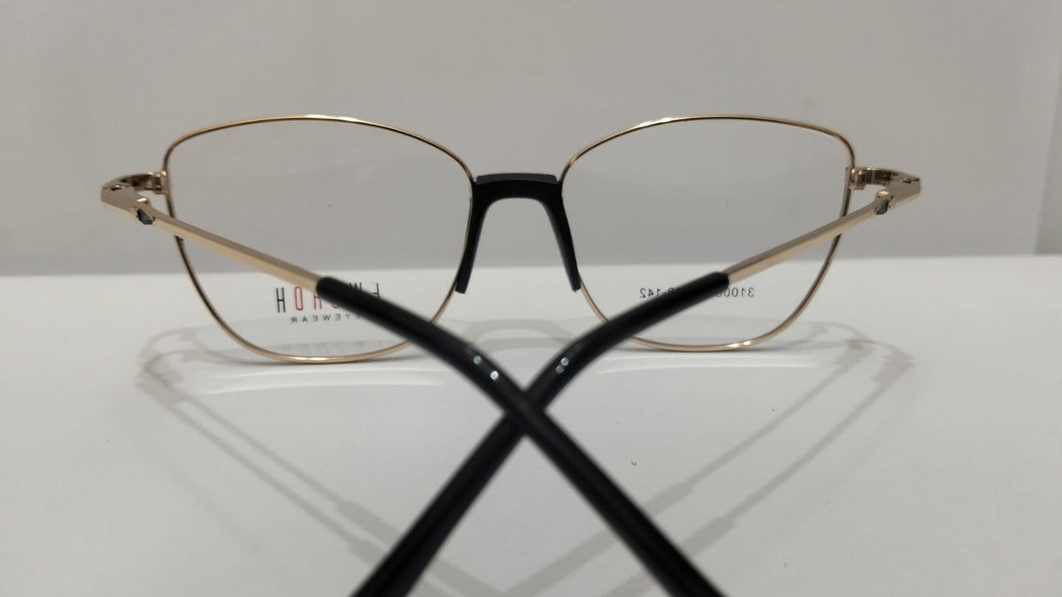 Back angle view of black and gold-tone eyeglasses