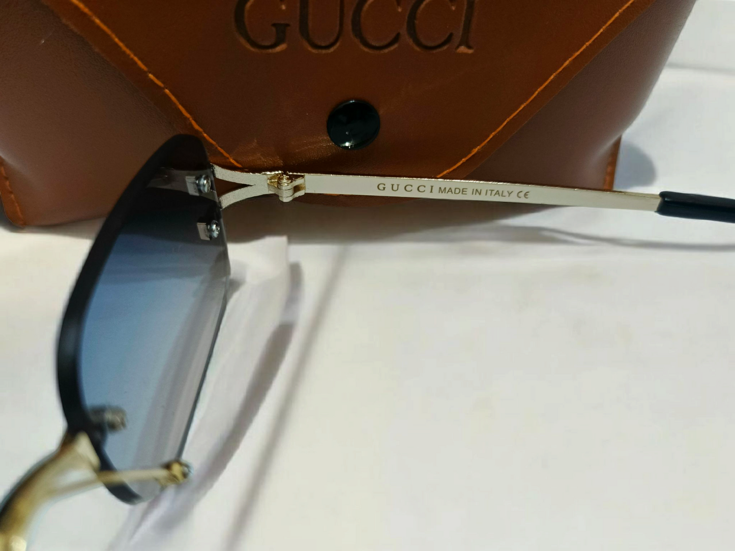 Gucci Inspired Rimless Gradient Sunglasses with Gold Accents - Made in Italy mentioned.